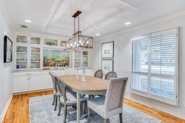 dining space featuring crown molding, visible vents, and light wood-type flooring