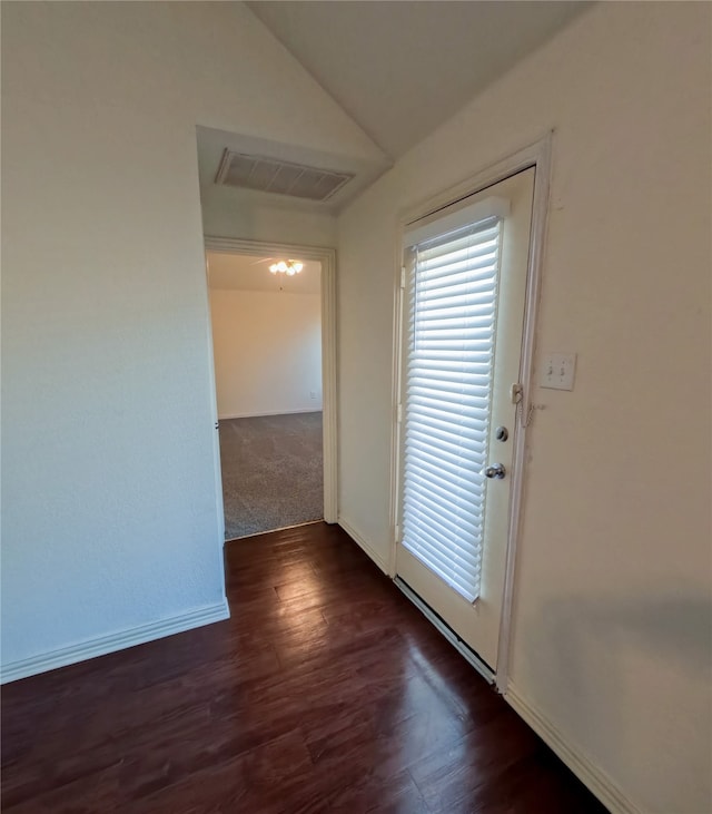 entryway featuring vaulted ceiling and dark hardwood / wood-style flooring