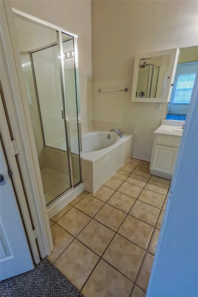 bathroom featuring independent shower and bath, vanity, and tile patterned floors