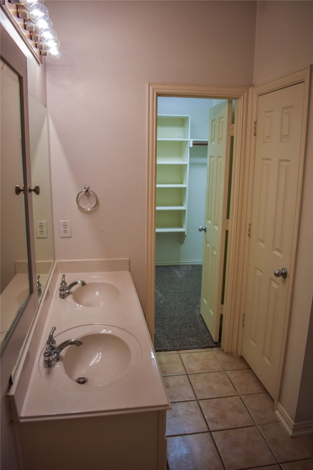 bathroom with tile patterned flooring and vanity