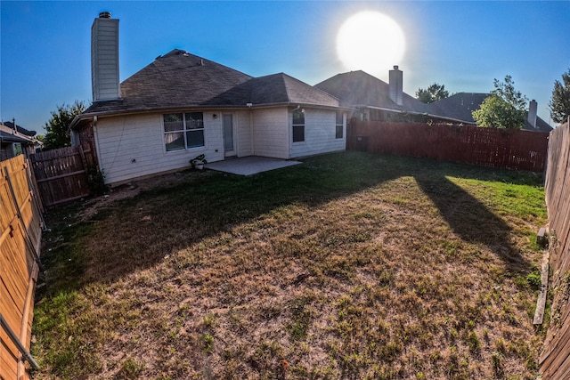 rear view of property with a patio and a yard