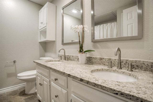 bathroom featuring toilet and vanity