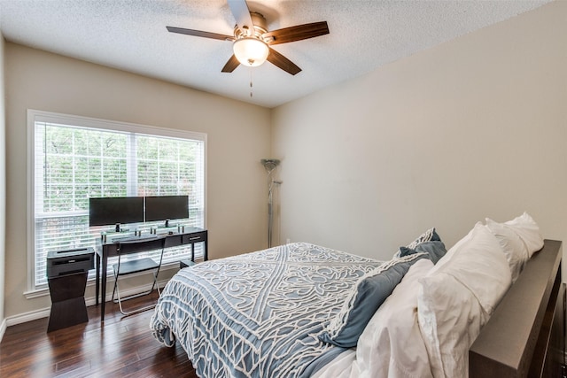 bedroom featuring ceiling fan, dark hardwood / wood-style floors, and a textured ceiling