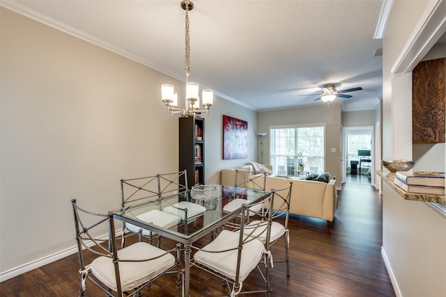 dining area with ceiling fan with notable chandelier, dark wood-type flooring, a textured ceiling, and ornamental molding