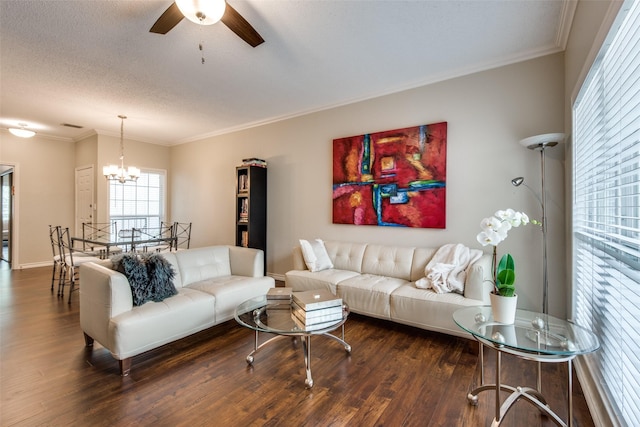 living room with ceiling fan with notable chandelier, crown molding, and dark hardwood / wood-style flooring