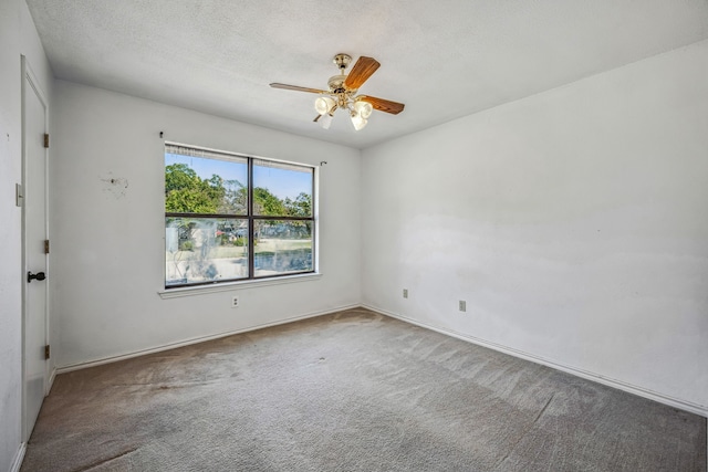 spare room with ceiling fan, a textured ceiling, and carpet flooring