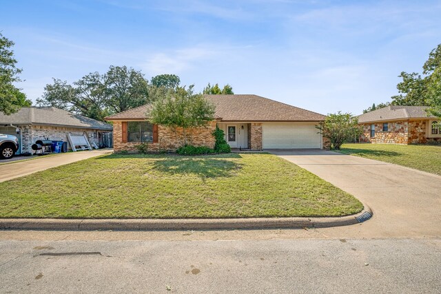 ranch-style house featuring a front yard and a garage