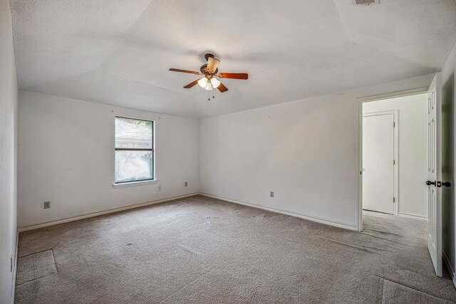 carpeted empty room featuring ceiling fan, a textured ceiling, and lofted ceiling