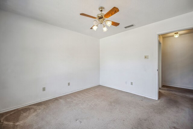 empty room with ceiling fan and light colored carpet