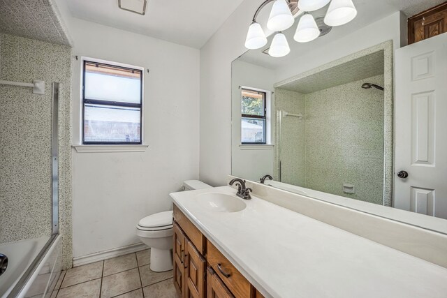 full bathroom featuring tile patterned flooring, combined bath / shower with glass door, vanity, and toilet