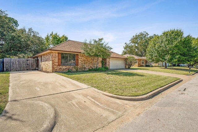 single story home featuring a garage and a front lawn