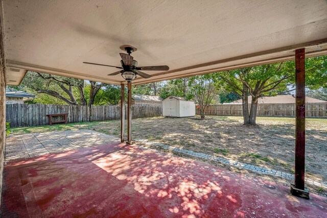 view of patio / terrace with ceiling fan and a storage unit