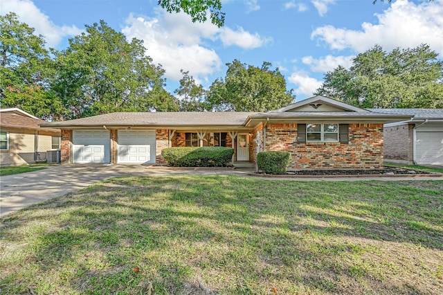 ranch-style house featuring a garage and a front lawn