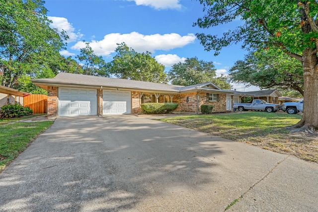 single story home with a garage and a front yard