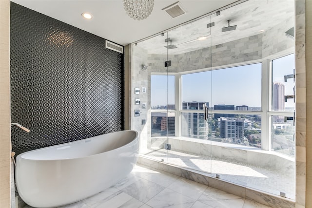 bathroom with a healthy amount of sunlight and separate shower and tub