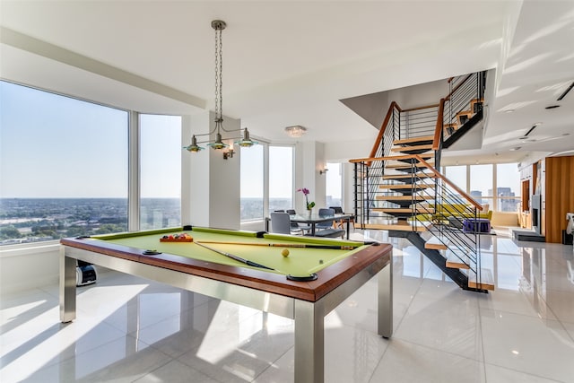 recreation room featuring pool table, a wealth of natural light, and light tile patterned floors