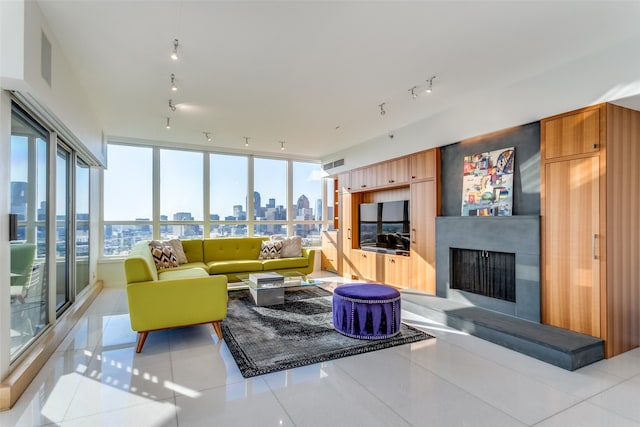 tiled living room with floor to ceiling windows and a large fireplace