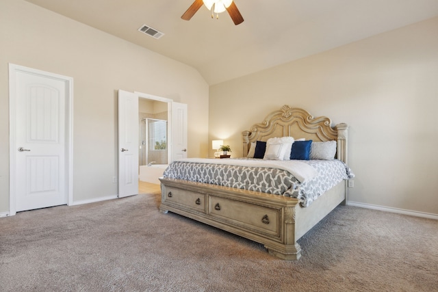 bedroom with ceiling fan, ensuite bathroom, carpet floors, and vaulted ceiling