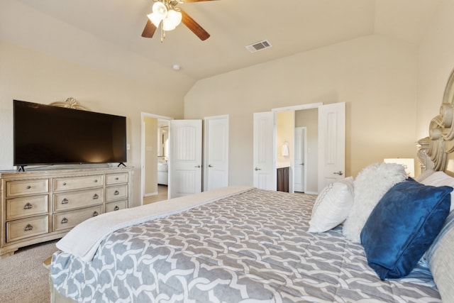 bedroom with ceiling fan, high vaulted ceiling, connected bathroom, and light carpet