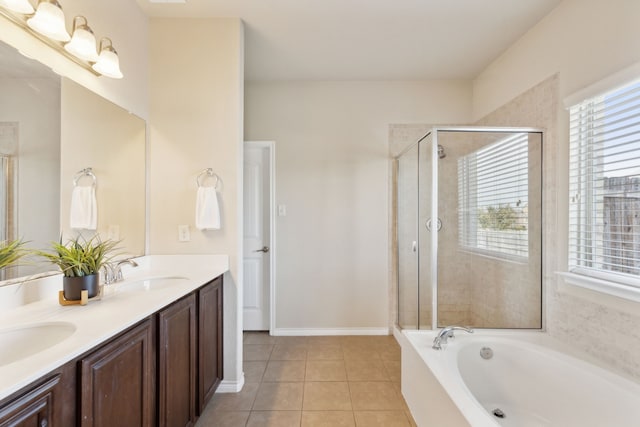 bathroom with tile patterned flooring, vanity, and shower with separate bathtub