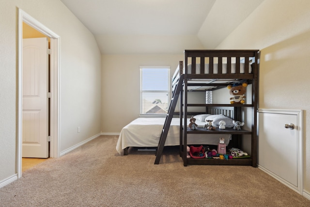 bedroom featuring lofted ceiling and light colored carpet