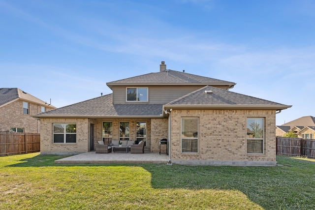 back of house with an outdoor living space, a yard, and a patio