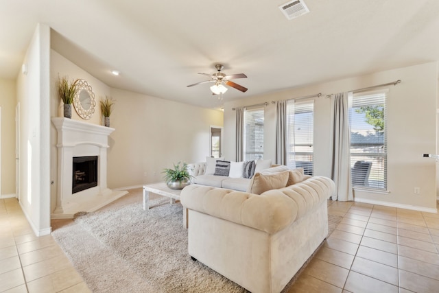 tiled living room with ceiling fan