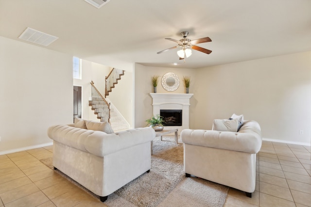 living room featuring light tile patterned flooring and ceiling fan