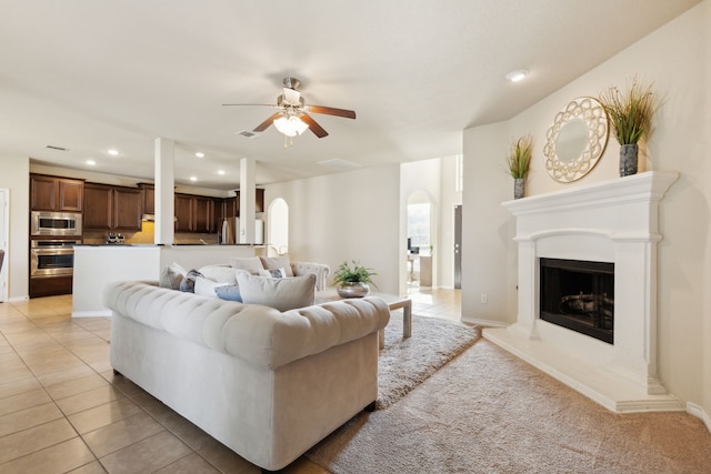 tiled living room featuring ceiling fan