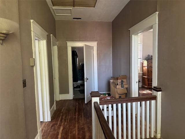 corridor with dark hardwood / wood-style flooring