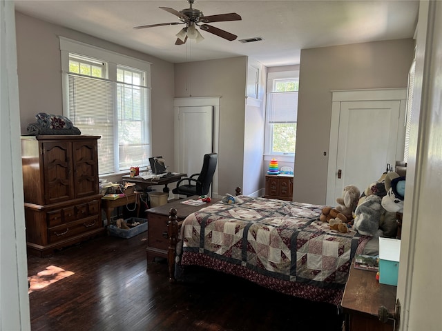 bedroom with ceiling fan and dark hardwood / wood-style floors