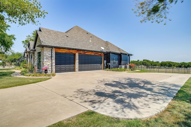 view of side of property featuring a garage and a yard