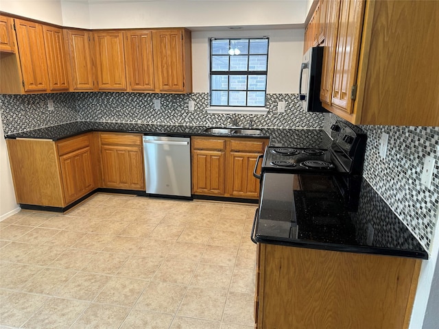 kitchen with light tile patterned floors, backsplash, appliances with stainless steel finishes, and sink