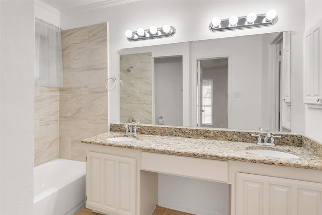 bathroom with vanity, tiled shower / bath combo, and crown molding