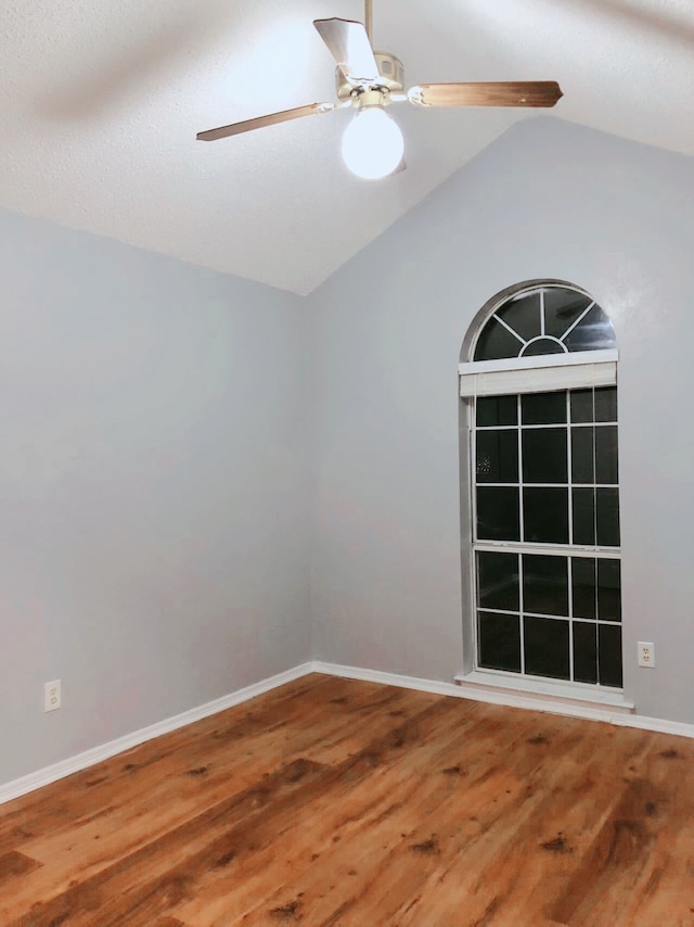 unfurnished room featuring ceiling fan, vaulted ceiling, and hardwood / wood-style floors