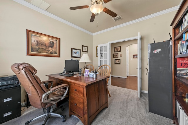 carpeted office with ornamental molding and ceiling fan