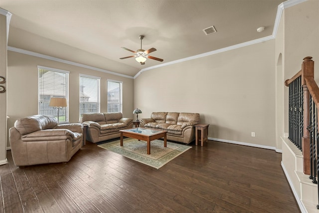 living room with ornamental molding, dark wood-type flooring, and ceiling fan