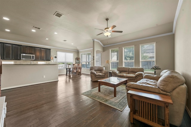 living room featuring a textured ceiling, crown molding, dark hardwood / wood-style floors, and ceiling fan