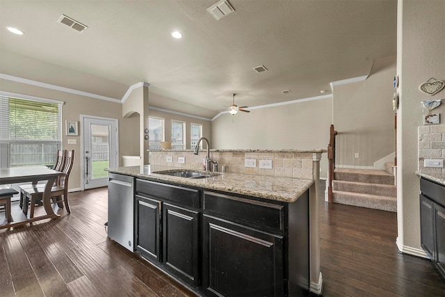 kitchen featuring backsplash, sink, stainless steel dishwasher, light stone counters, and dark hardwood / wood-style flooring