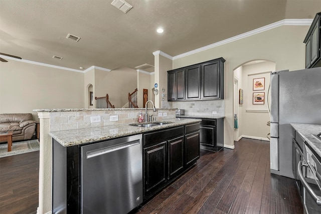 kitchen featuring decorative backsplash, dark hardwood / wood-style floors, stainless steel appliances, ornamental molding, and sink