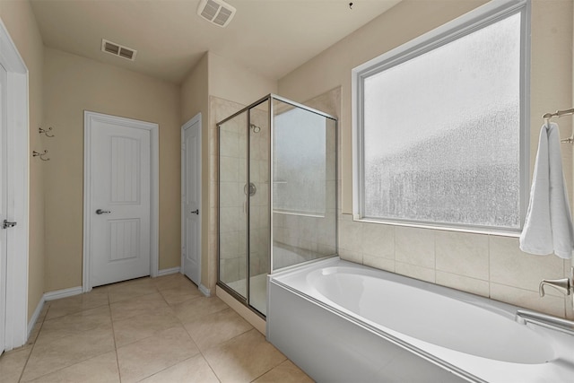 bathroom with tile patterned floors and separate shower and tub