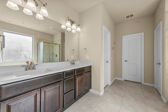 bathroom featuring vanity, tile patterned floors, and walk in shower