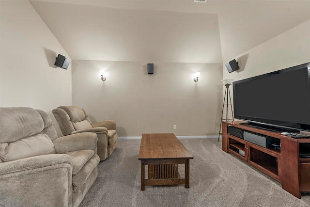 carpeted home theater room featuring lofted ceiling