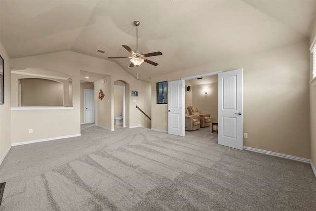 interior space featuring lofted ceiling, light carpet, and ceiling fan