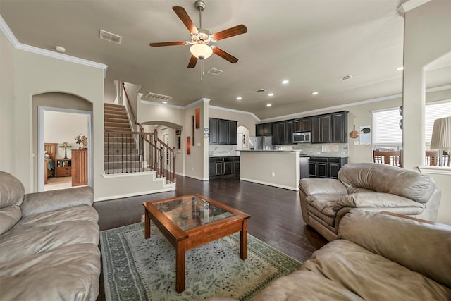 living room featuring crown molding, dark hardwood / wood-style floors, and ceiling fan