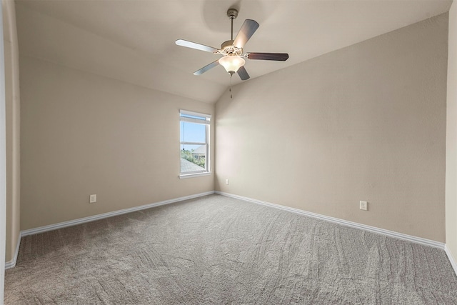 carpeted empty room with vaulted ceiling and ceiling fan