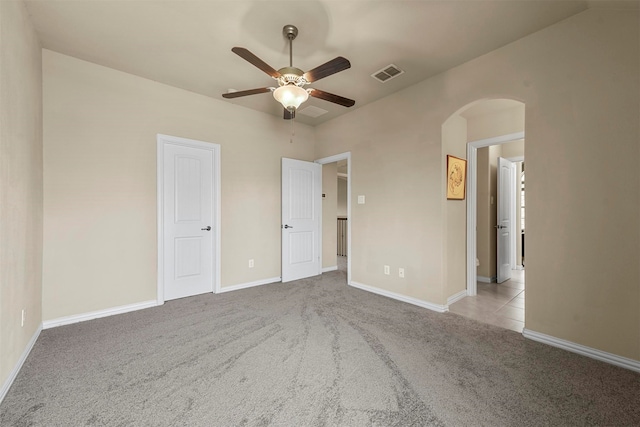 unfurnished bedroom featuring ceiling fan and light carpet