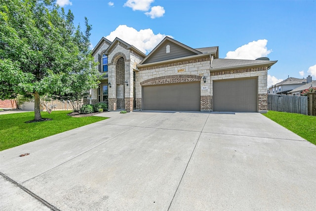 view of front facade with a front yard and a garage