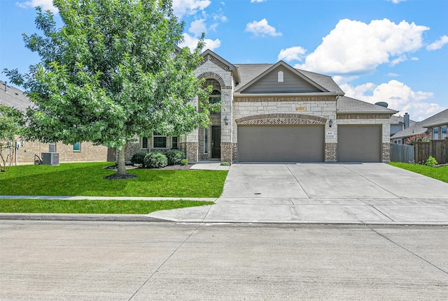 view of front of property featuring central AC, a front lawn, and a garage