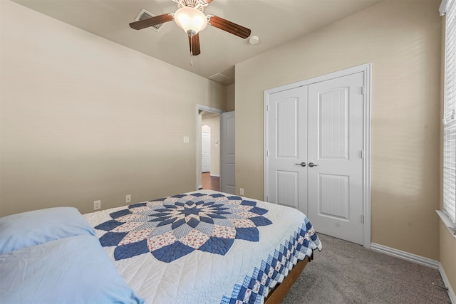 bedroom with a closet, ceiling fan, and carpet